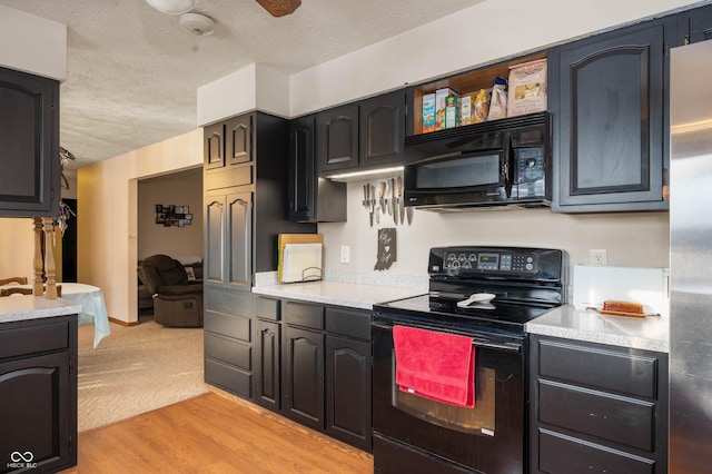 kitchen featuring ceiling fan, light hardwood / wood-style flooring, a textured ceiling, and black appliances