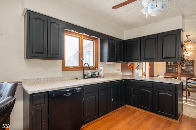 kitchen featuring dishwasher, sink, light hardwood / wood-style flooring, and kitchen peninsula