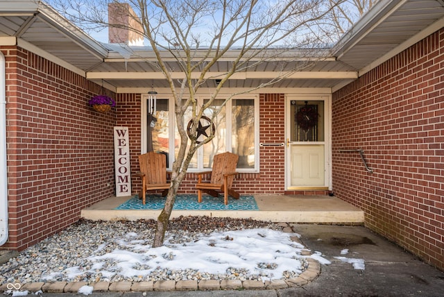 view of snow covered property entrance