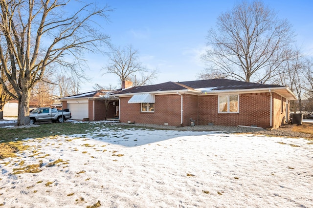 view of front of property with cooling unit and a garage