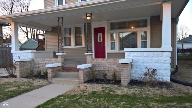 view of exterior entry with covered porch