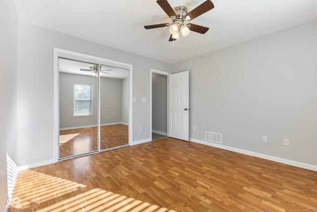 2395 W Robin Rd, Scottsburg, IN 47170 - unfurnished bedroom with wood finished floors, a closet, and ceiling fan