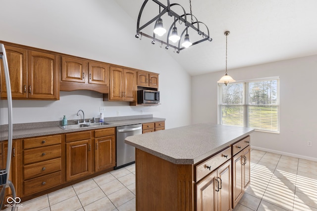 kitchen featuring sink, a center island, stainless steel appliances, vaulted ceiling, and light tile patterned flooring