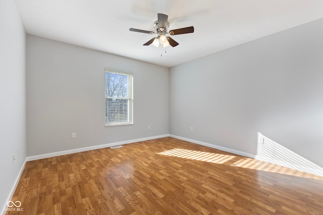 spare room with ceiling fan and wood-type flooring