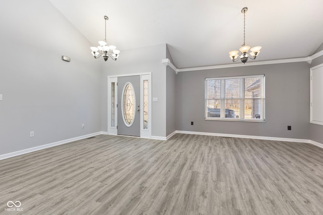 2395 W Robin Rd, Scottsburg, IN 47170 - entrance foyer featuring a chandelier, light wood-style flooring, ornamental molding, and high vaulted ceiling