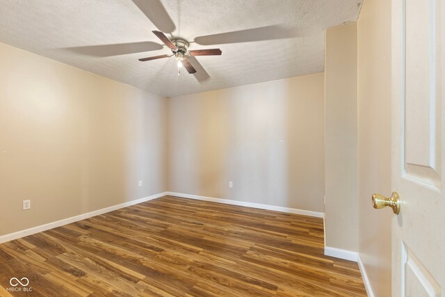 unfurnished room with ceiling fan, wood-type flooring, and a textured ceiling