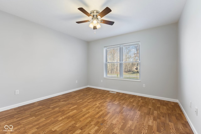 empty room with ceiling fan and wood-type flooring