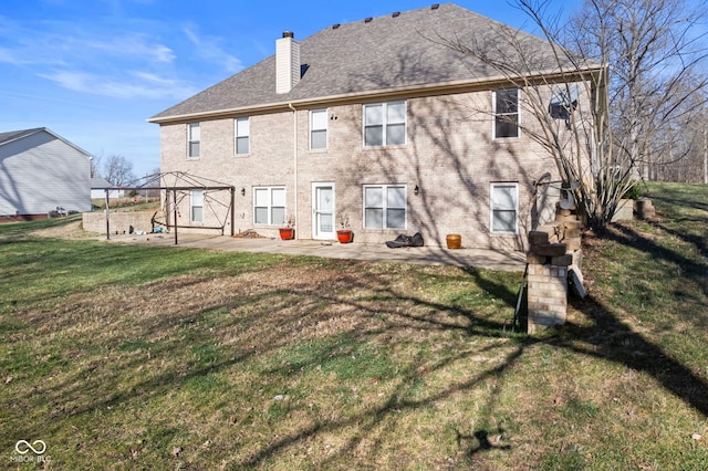 back of property with a lawn, a gazebo, and a patio area