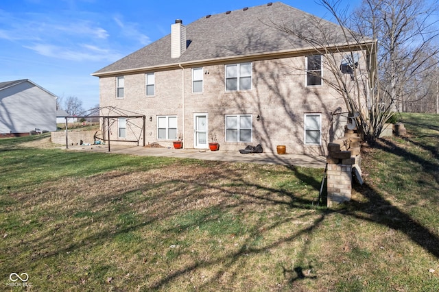 2395 W Robin Rd, Scottsburg, IN 47170 - rear view of house featuring a patio area, a chimney, a lawn, and a shingled roof