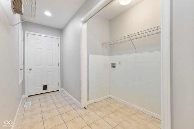 laundry area featuring hookup for a washing machine and light tile patterned floors