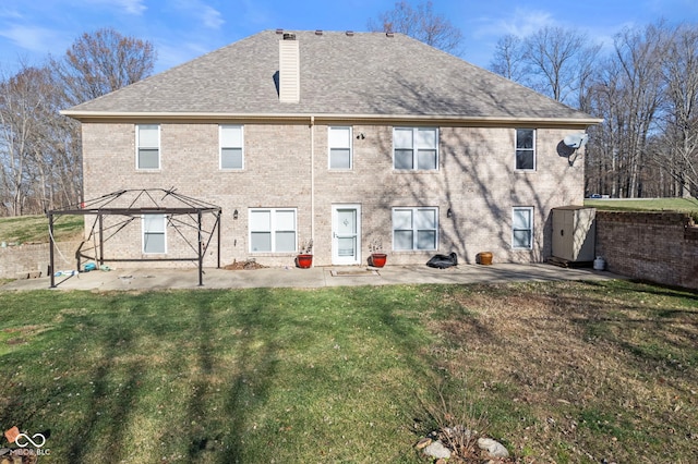 2395 W Robin Rd, Scottsburg, IN 47170 - back of house featuring a patio area, a yard, a shingled roof, a chimney, and brick siding