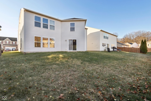 rear view of property with a yard