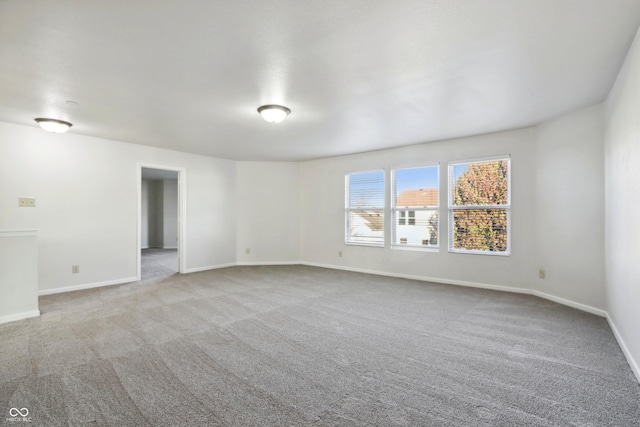 unfurnished room with light carpet