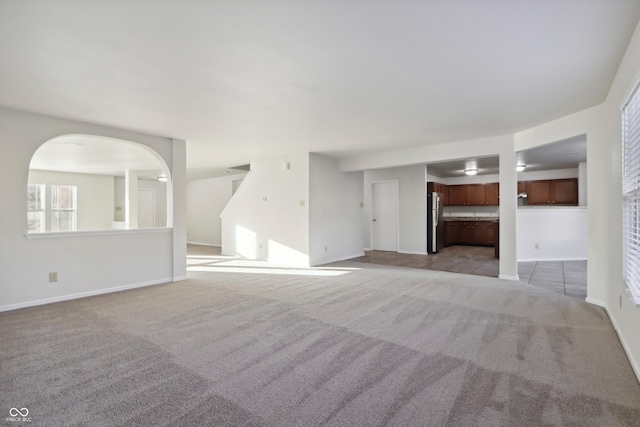 unfurnished living room with light colored carpet