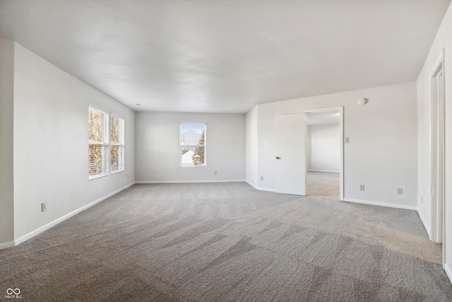 unfurnished room with light carpet