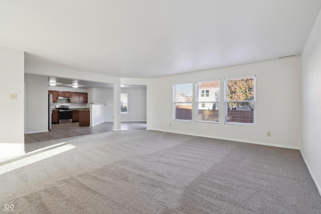 unfurnished living room featuring light carpet