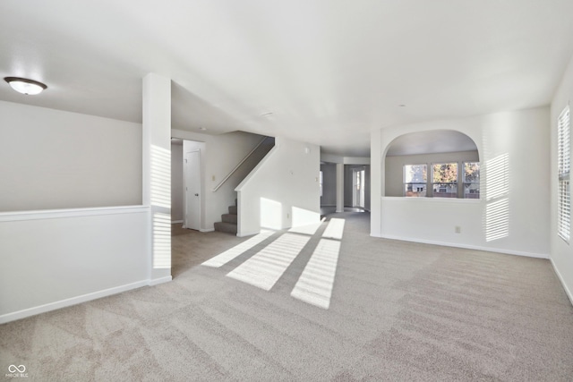 unfurnished living room with light colored carpet