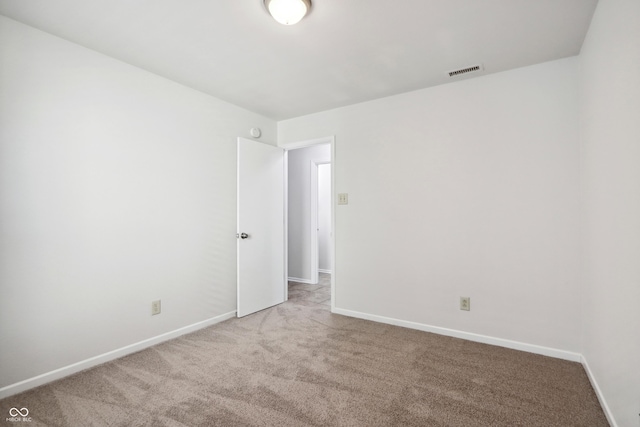 unfurnished room with light carpet