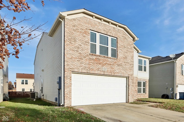 view of front facade featuring a front yard, a garage, and central air condition unit