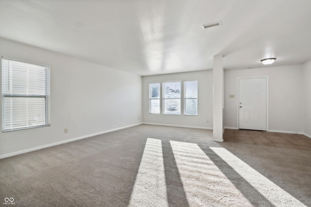 unfurnished living room with carpet