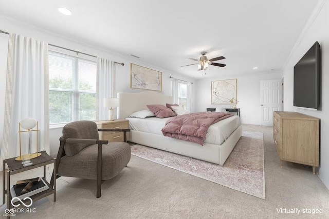 carpeted bedroom with ceiling fan and ornamental molding