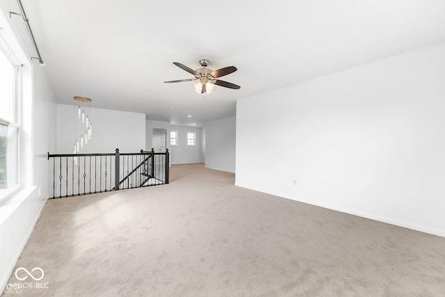 carpeted empty room with ceiling fan