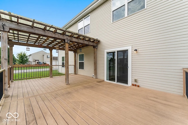 deck with a lawn and a pergola