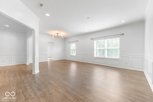 spare room with light hardwood / wood-style flooring and ornamental molding