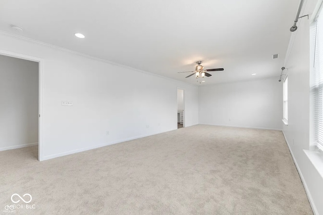 unfurnished room with crown molding, ceiling fan, and light carpet