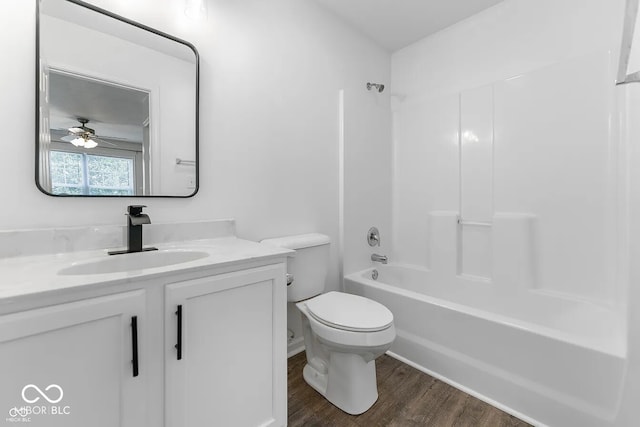 full bathroom with vanity, washtub / shower combination, ceiling fan, toilet, and wood-type flooring