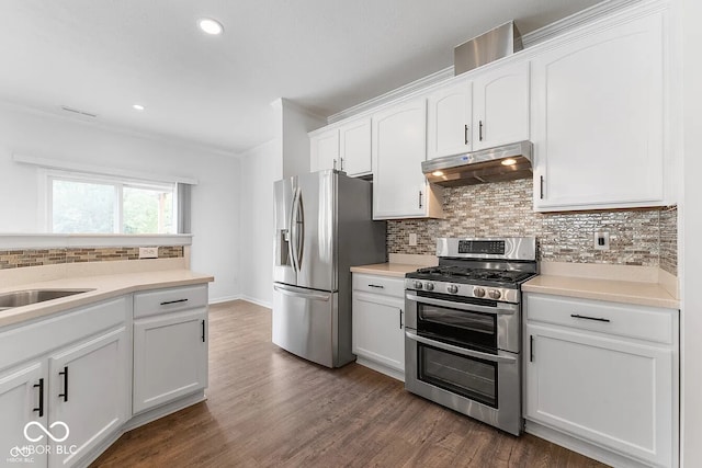 kitchen featuring white cabinets, backsplash, dark wood-type flooring, and appliances with stainless steel finishes