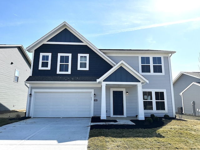 view of front of house with a front yard, an attached garage, board and batten siding, and driveway