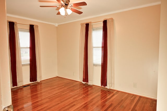 empty room featuring crown molding, hardwood / wood-style floors, and ceiling fan