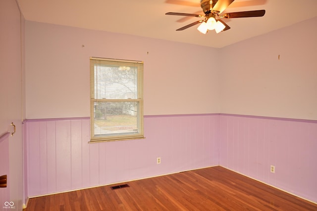 spare room featuring hardwood / wood-style flooring and ceiling fan