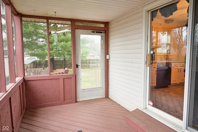 unfurnished sunroom with plenty of natural light and sink