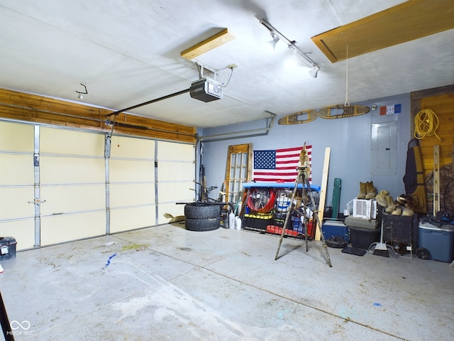 garage with electric panel and a garage door opener