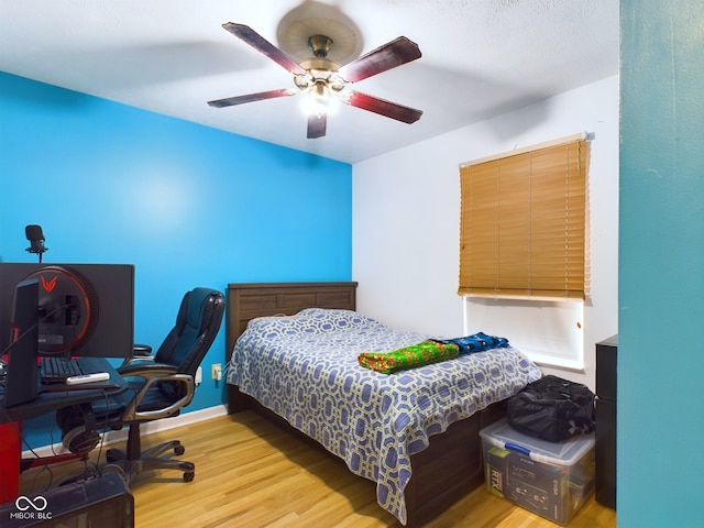 bedroom with ceiling fan and light wood-type flooring