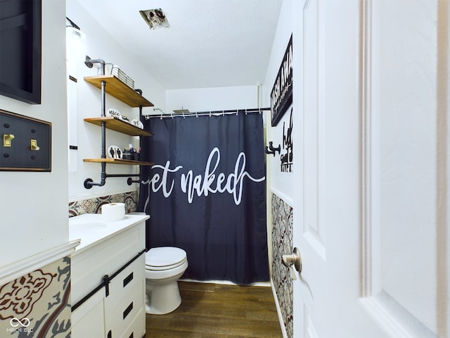 bathroom featuring curtained shower, vanity, wood-type flooring, and toilet