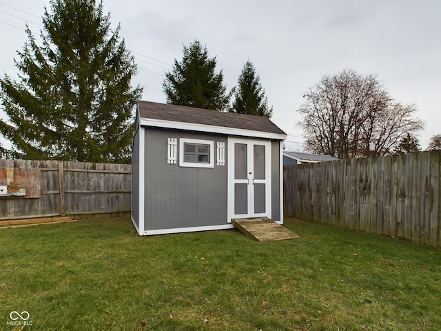 view of outbuilding with a yard