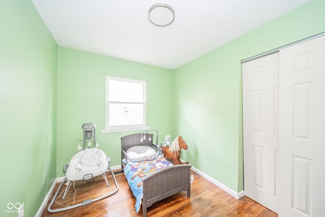 bedroom featuring wood-type flooring and a closet