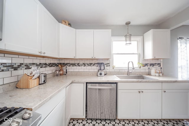 kitchen featuring white cabinets, stainless steel appliances, hanging light fixtures, and sink