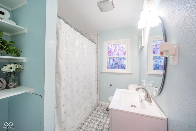 bathroom with vanity, toilet, and walk in shower