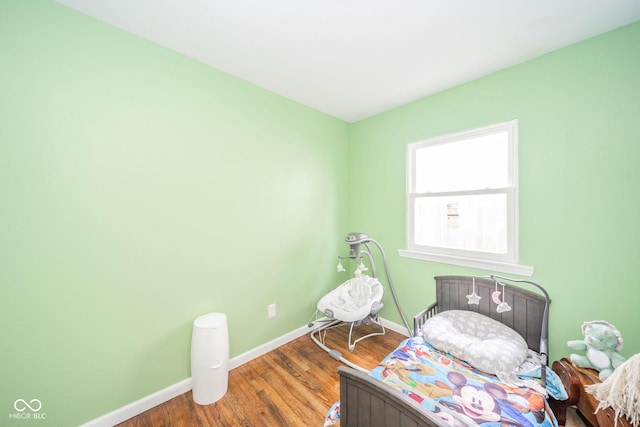 bedroom with hardwood / wood-style floors