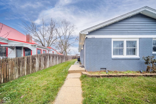 view of side of home featuring a yard