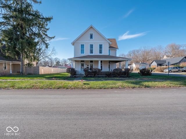 view of front of property with a porch and a front yard