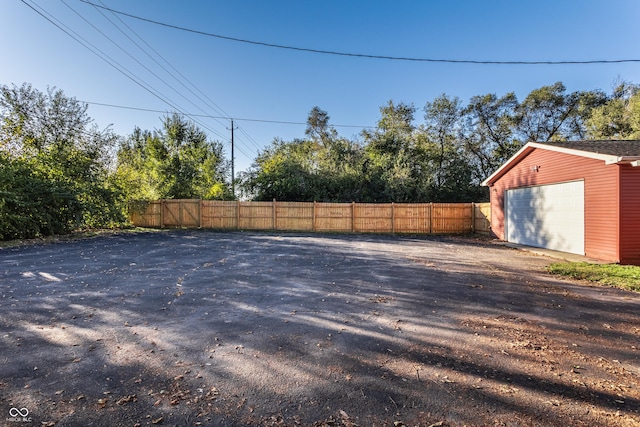 view of yard featuring a garage and an outbuilding