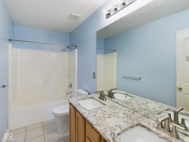 full bathroom featuring vanity, a textured ceiling, washtub / shower combination, tile patterned flooring, and toilet