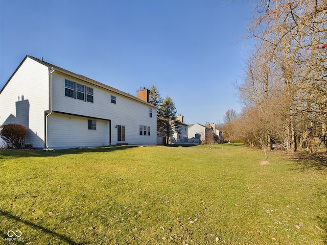 rear view of property with a lawn