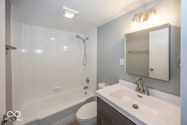 full bathroom with tiled shower / bath, vanity, and toilet