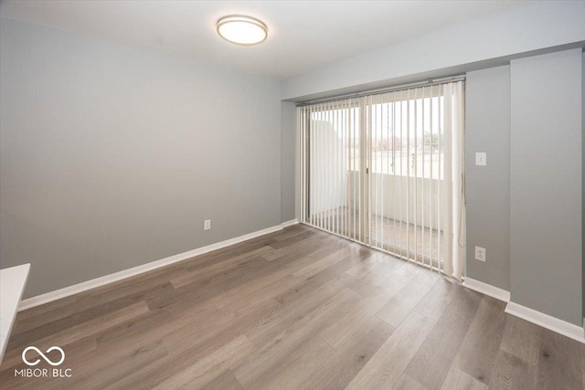 spare room with hardwood / wood-style flooring